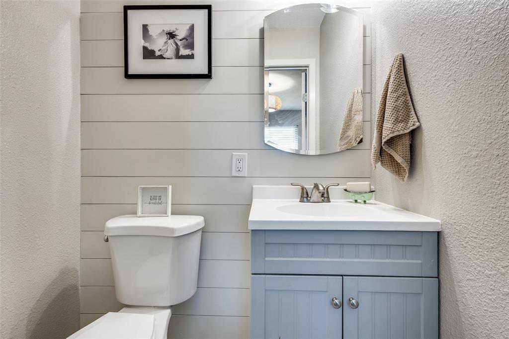 1200 Tipps Road Cross Roads, TX 76227 - Photo 21 of 32 a bathroom with a toilet sink and mirror