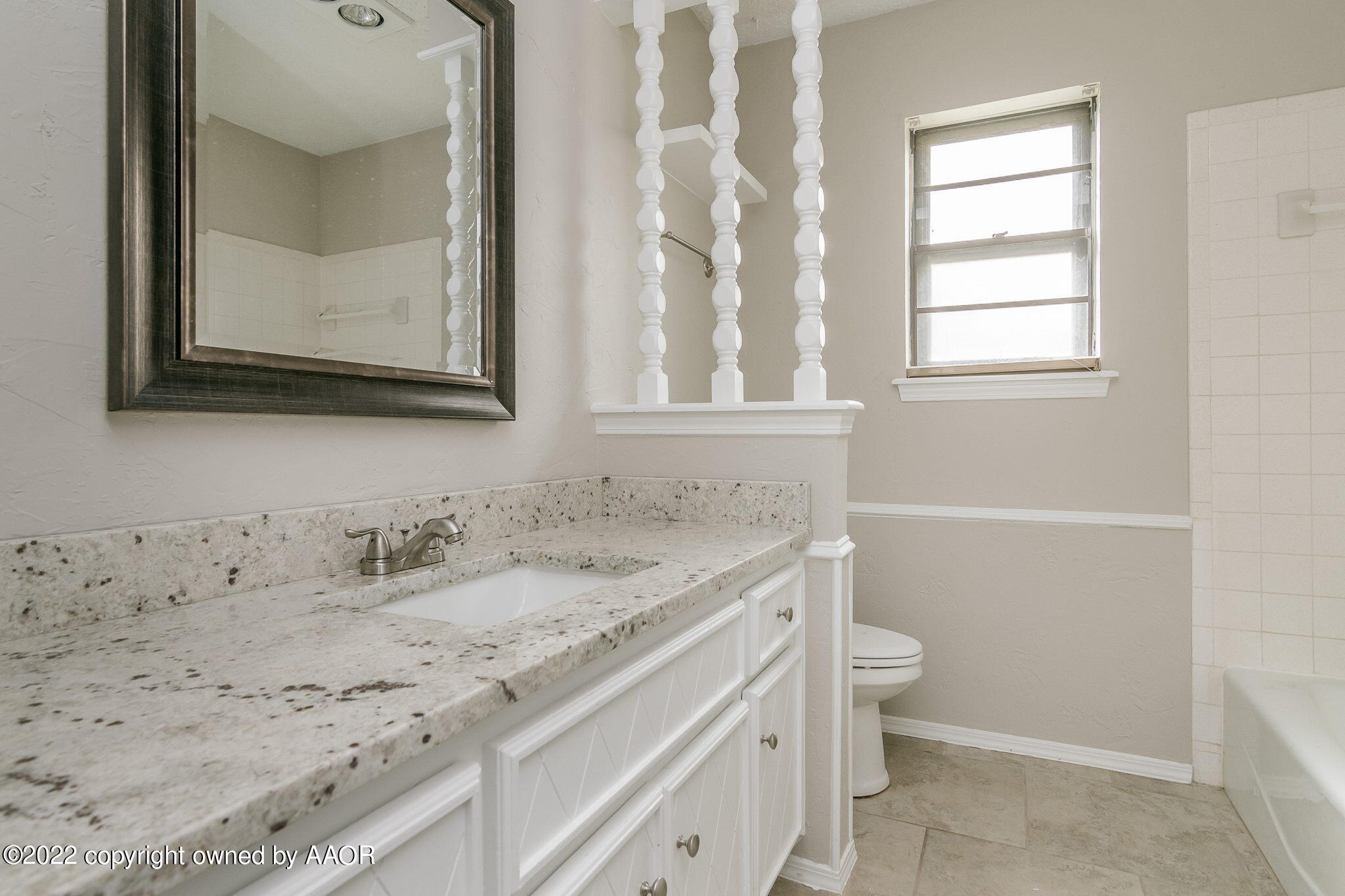 7720 Canode Drive Amarillo, TX 79121 - Photo 11 of 21 a bathroom with a granite countertop sink toilet and mirror
