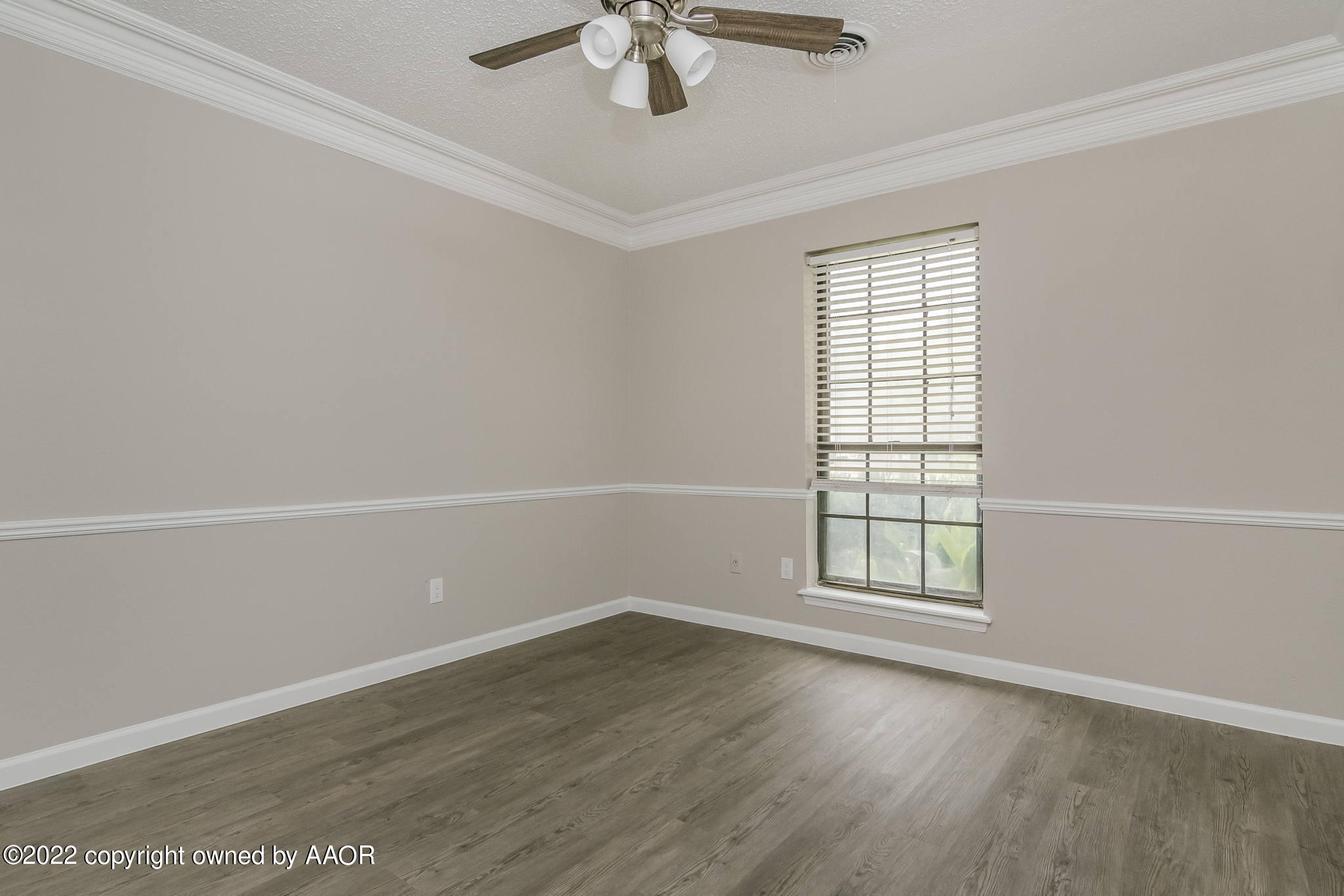 7720 Canode Drive Amarillo, TX 79121 - Photo 12 of 21 an empty room with wooden floor fan and windows