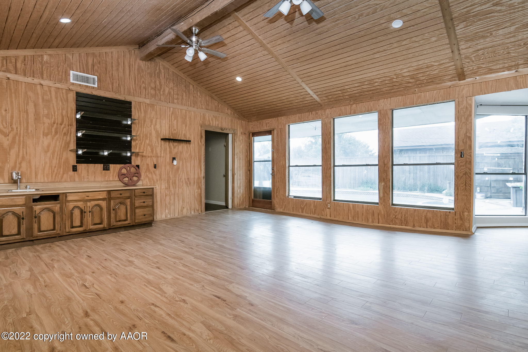 7720 Canode Drive Amarillo, TX 79121 - Photo 13 of 21 a view of an empty room with a window and wooden floor