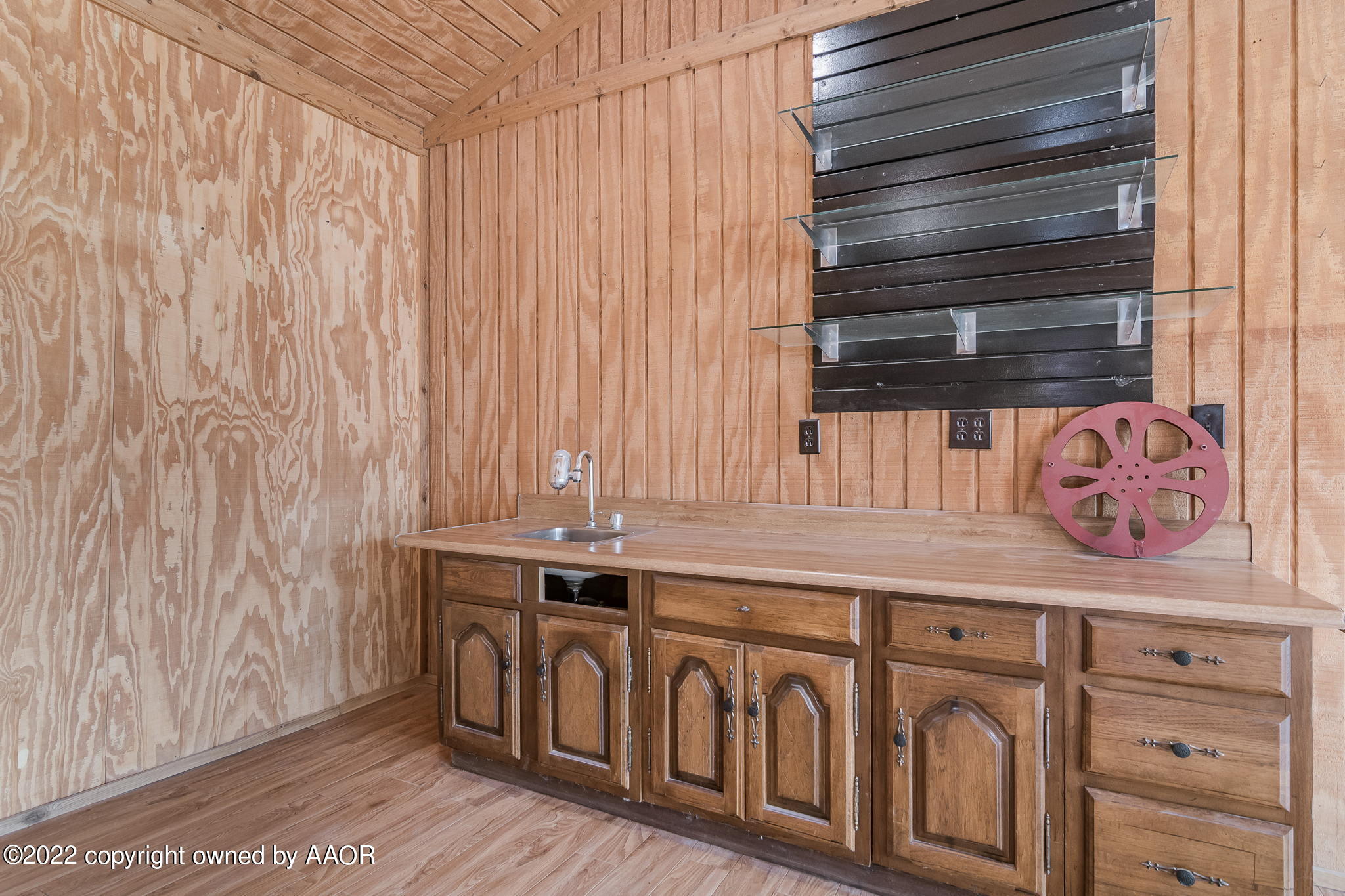 7720 Canode Drive Amarillo, TX 79121 - Photo 15 of 21 a kitchen with a sink and cabinets