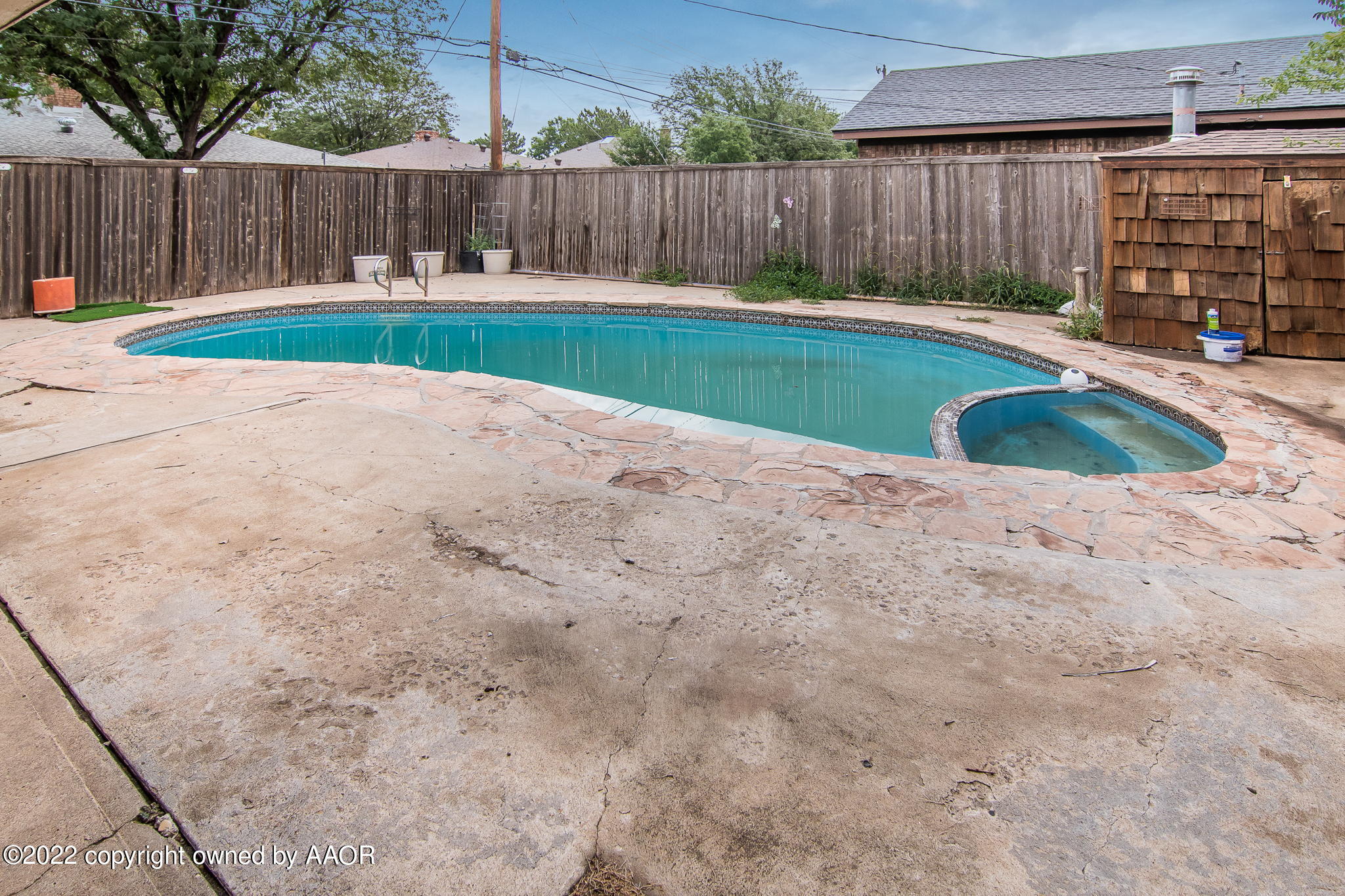7720 Canode Drive Amarillo, TX 79121 - Photo 18 of 21 a view of a backyard with a small cabin