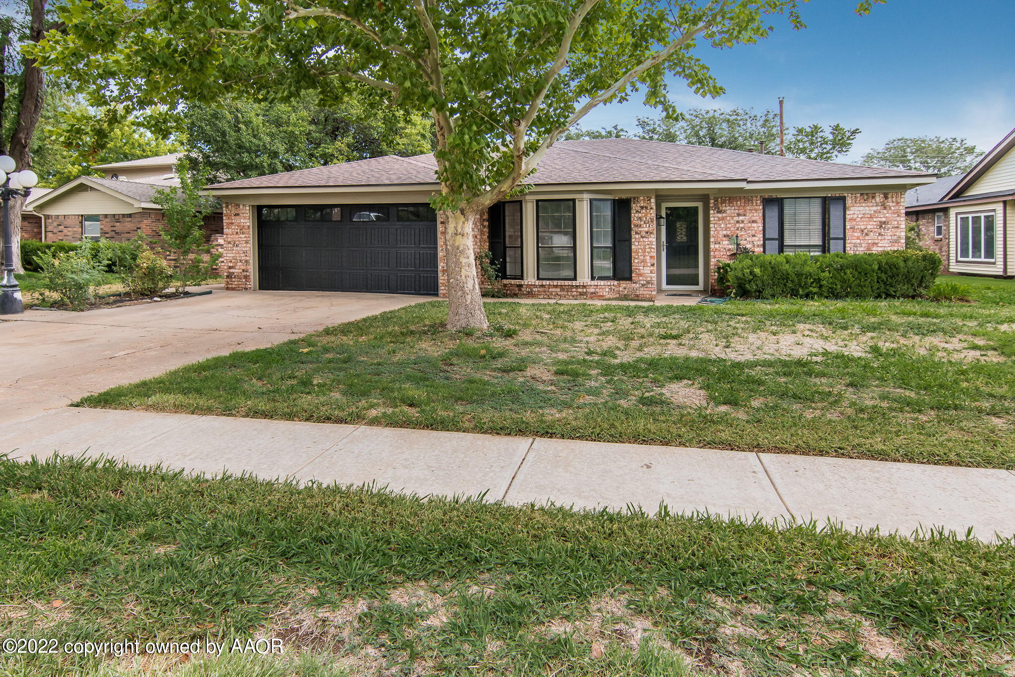 7720 Canode Drive Amarillo, TX 79121 - Photo 2 of 21 a front view of a house with garden