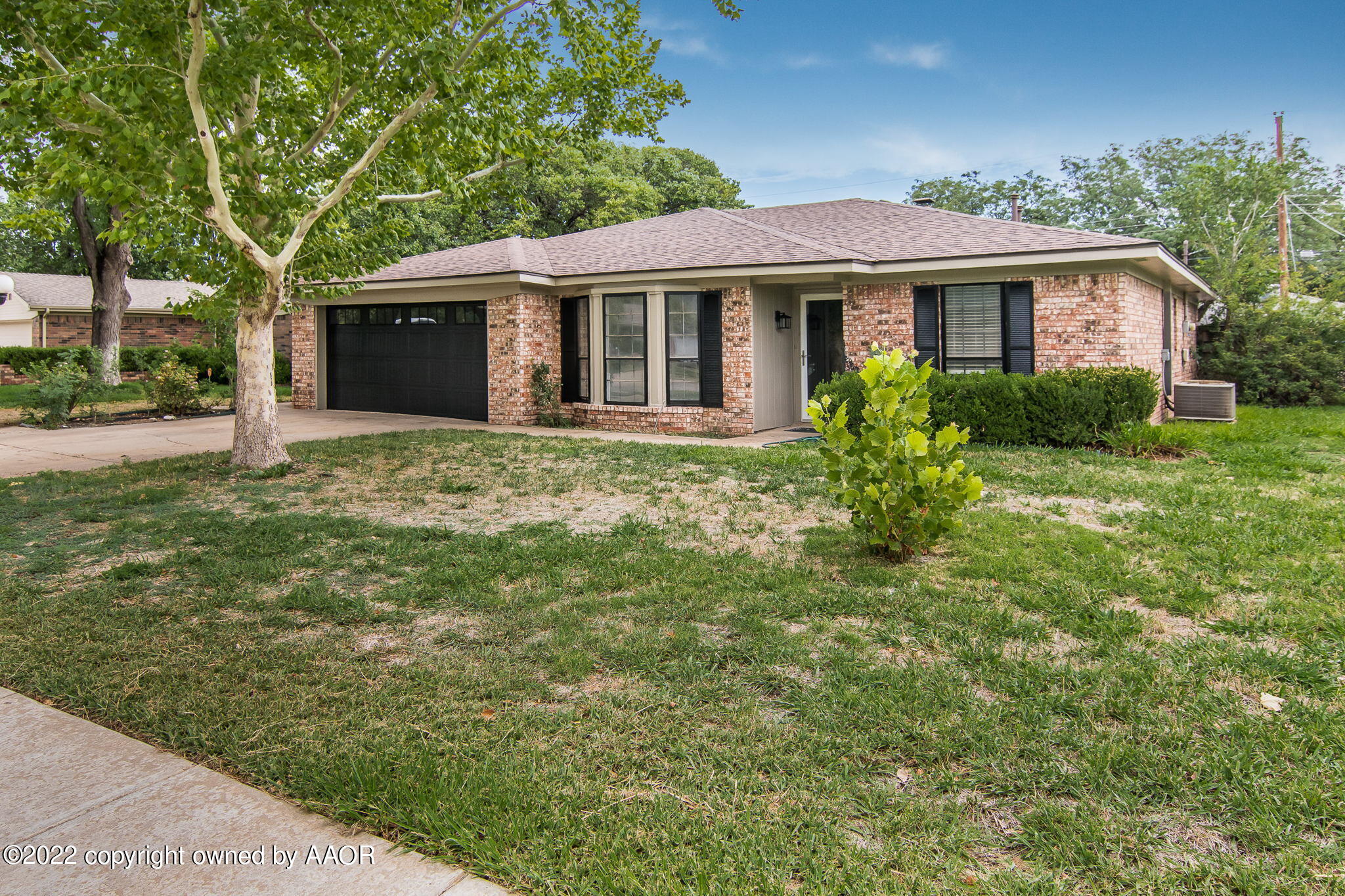 7720 Canode Drive Amarillo, TX 79121 - Photo 21 of 21 a front view of a house with a garden