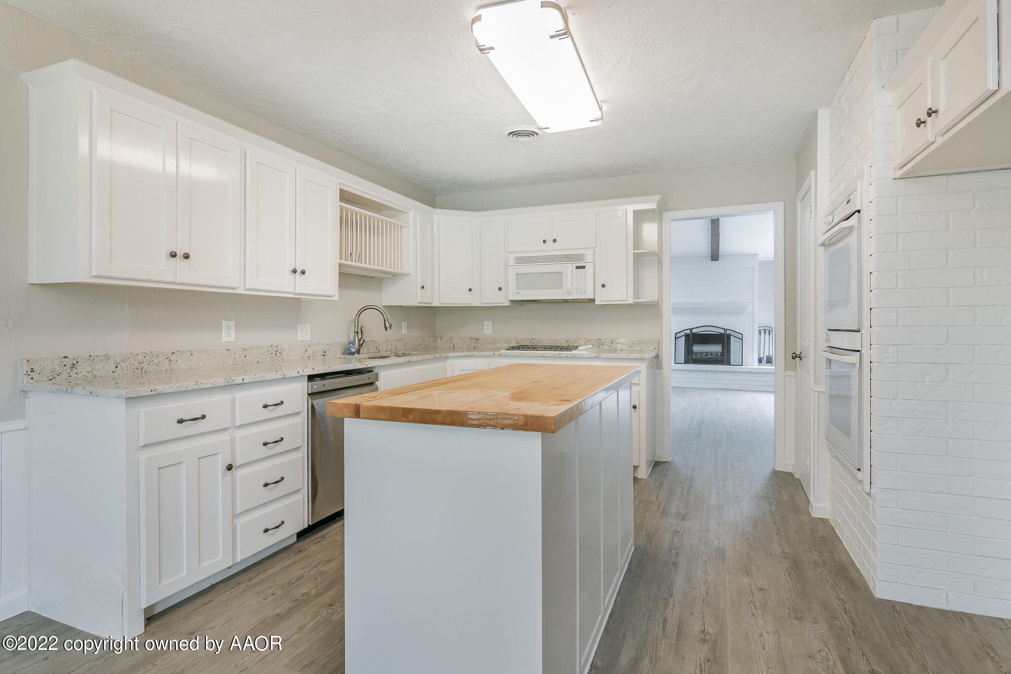 7720 Canode Drive Amarillo, TX 79121 - Photo 4 of 21 a kitchen with granite countertop white cabinets and white appliances