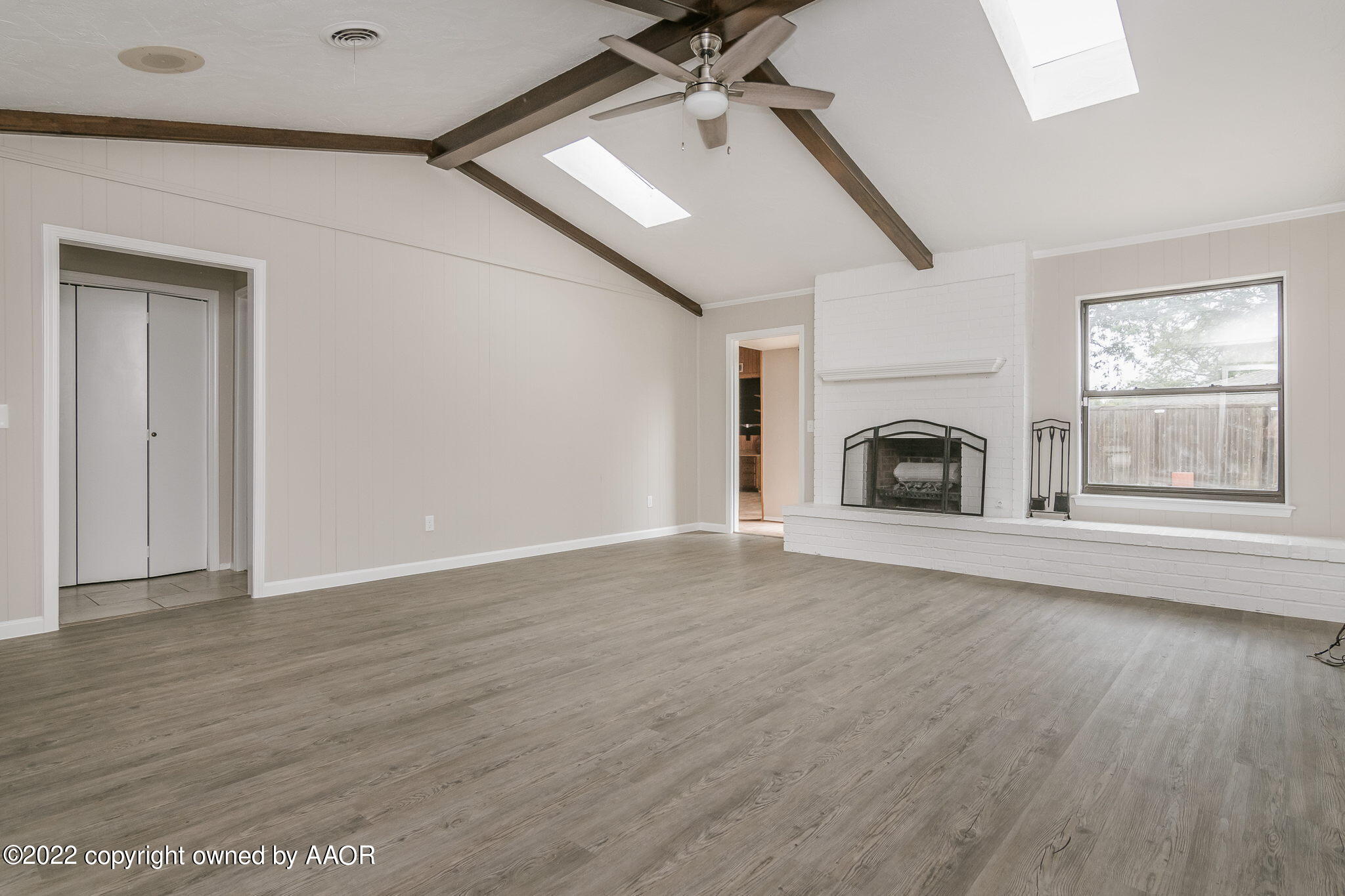 7720 Canode Drive Amarillo, TX 79121 - Photo 6 of 21 a view of empty room with fireplace and wooden floor