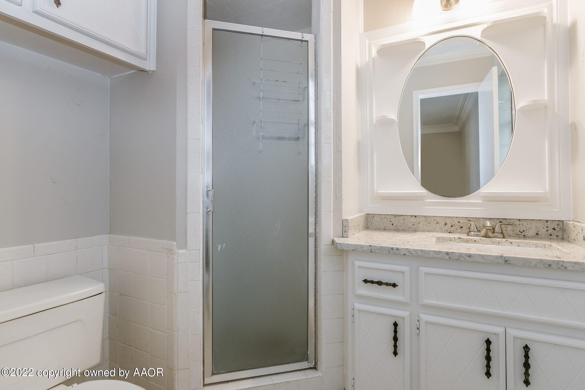 7720 Canode Drive Amarillo, TX 79121 - Photo 9 of 21 a bathroom with a granite countertop sink a toilet and a mirror