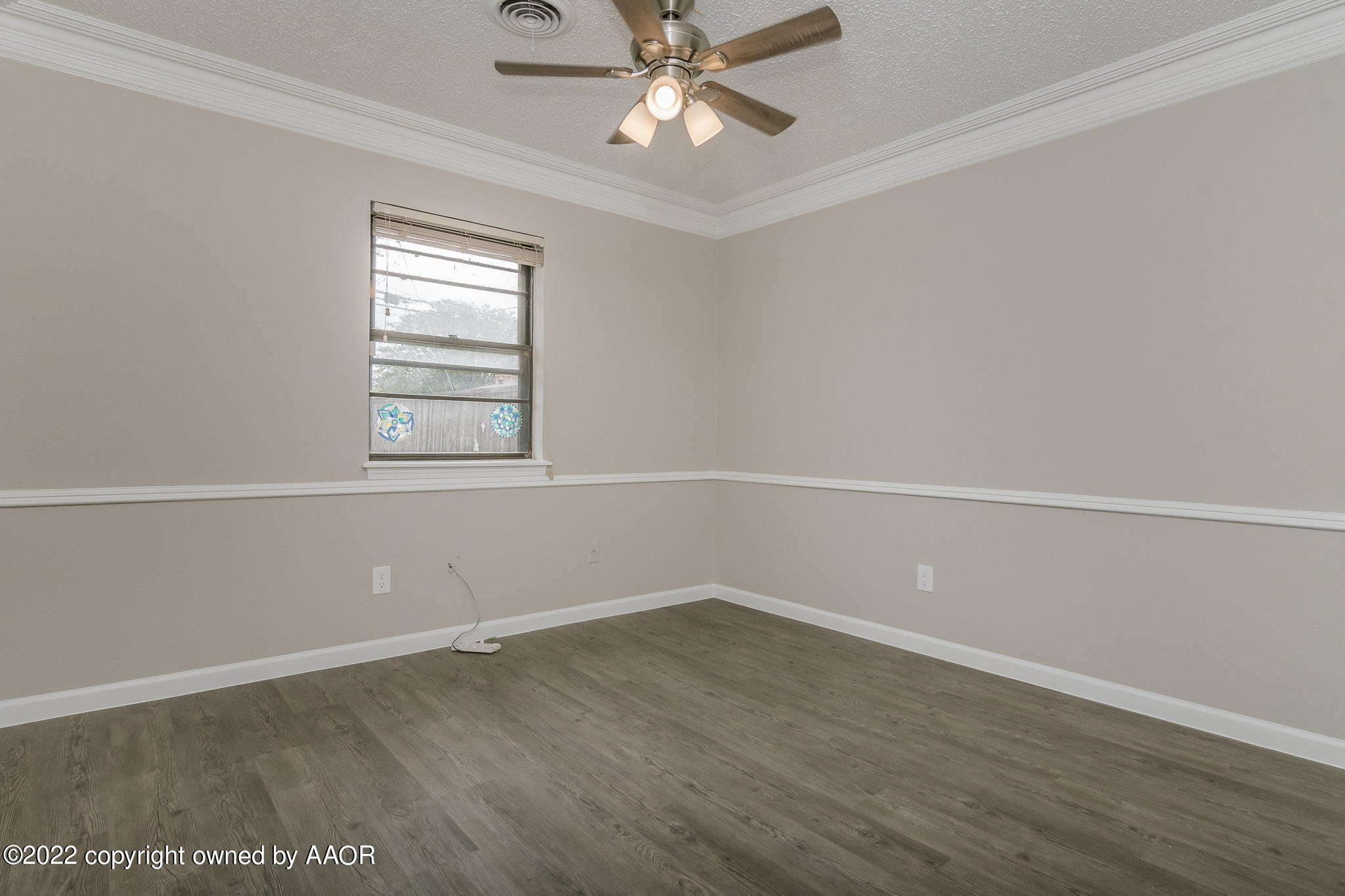 7720 Canode Drive Amarillo, TX 79121 - Photo 10 of 21 an empty room with a window and a ceiling fan