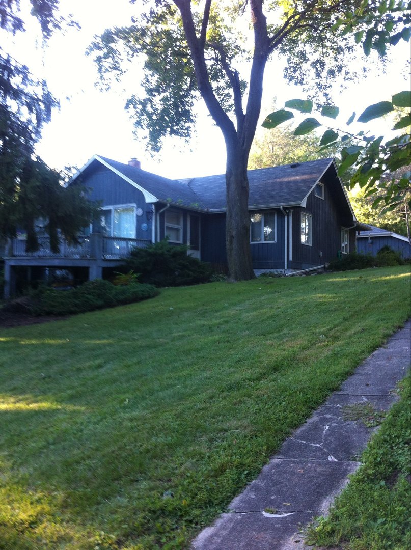 401 Woodbine Road Cary, IL 60013 - Photo 2 of 19 a tree in front of a house with a tree