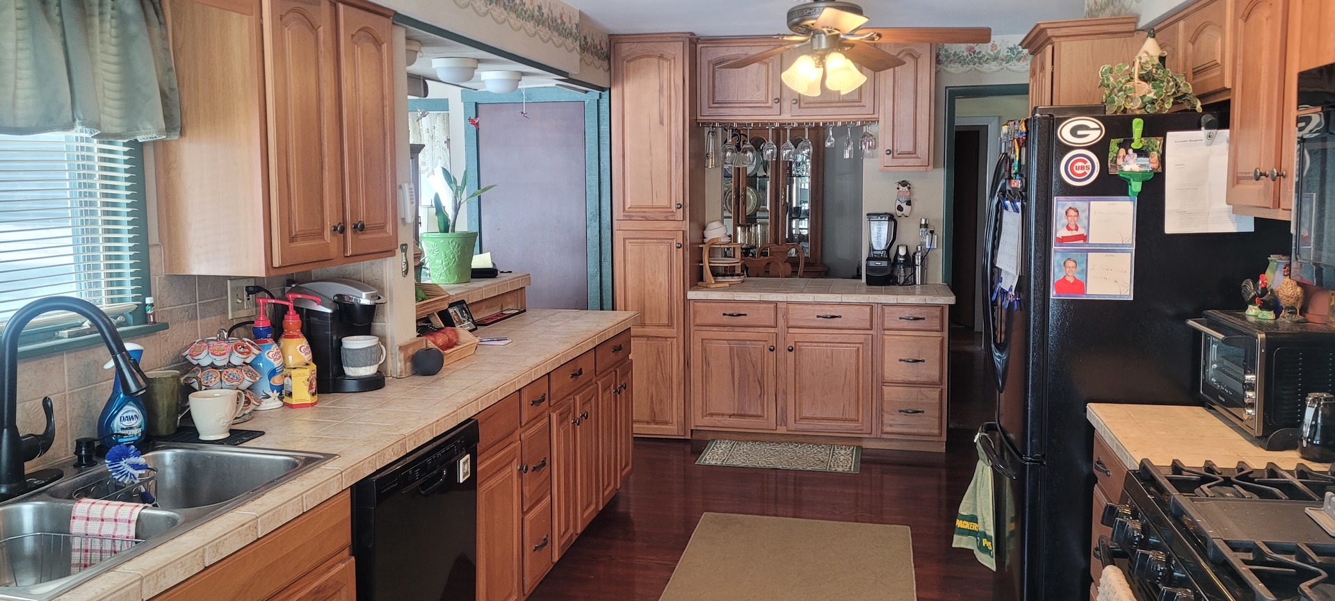 401 Woodbine Road Cary, IL 60013 - Photo 5 of 19 a kitchen with a sink stove and cabinets