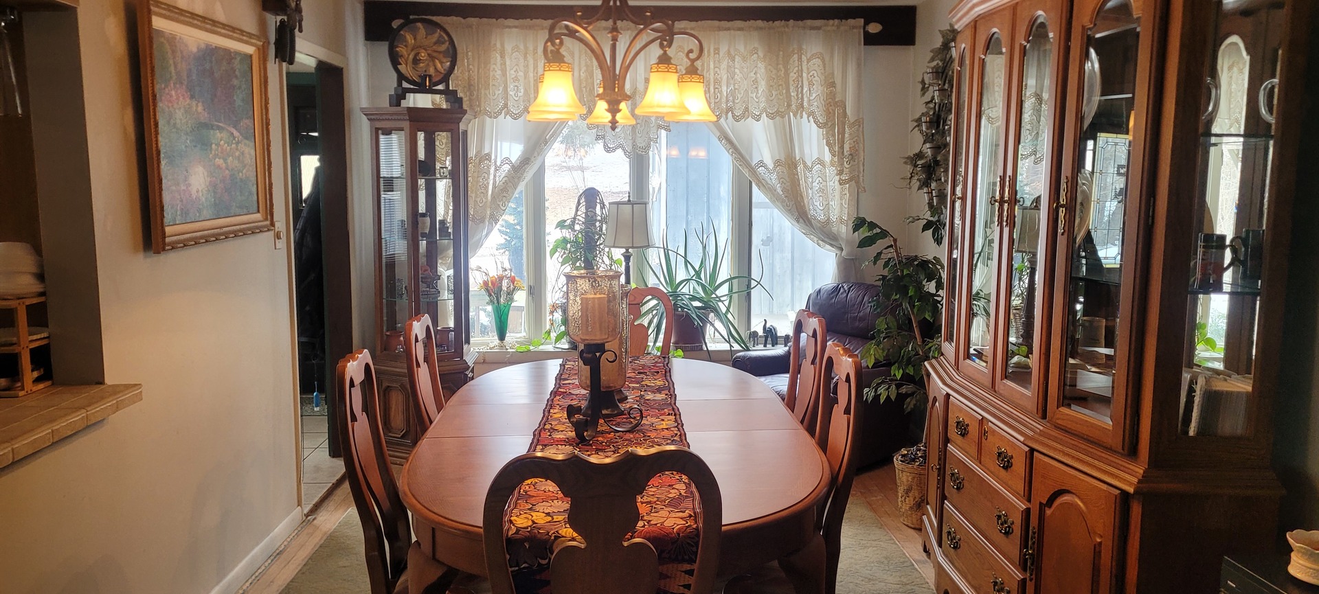 401 Woodbine Road Cary, IL 60013 - Photo 8 of 19 a dining room with furniture and a chandelier