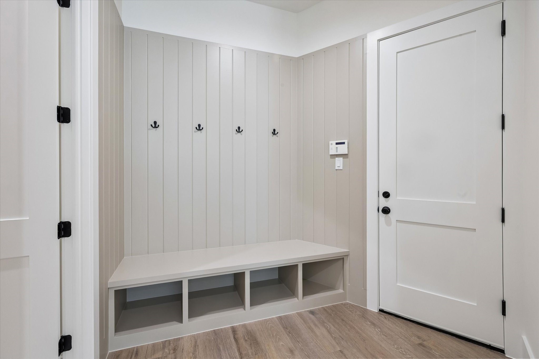 65 Shadow Creek Ridge Drive Spring, TX 77389 - Photo 27 of 41 Stylish mudroom entry with built-in bench, open cubbies, and shiplap wall with coat hooks.