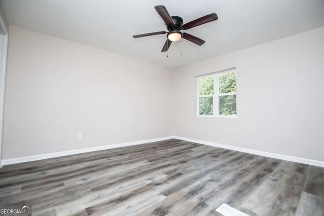 wooden floor in an empty room with a window