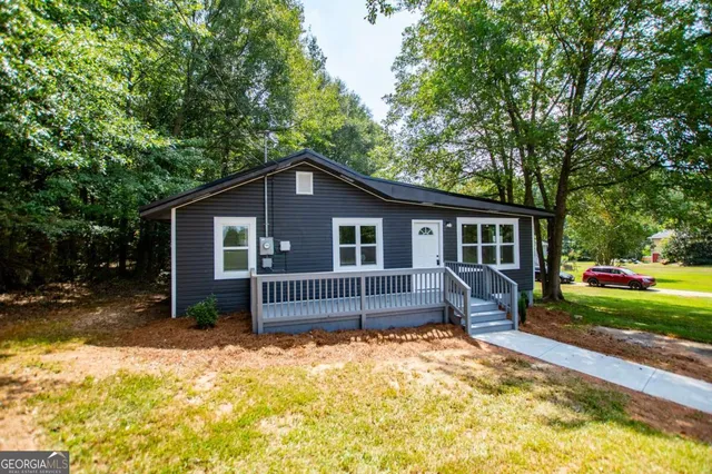 a view of backyard with a deck and furniture