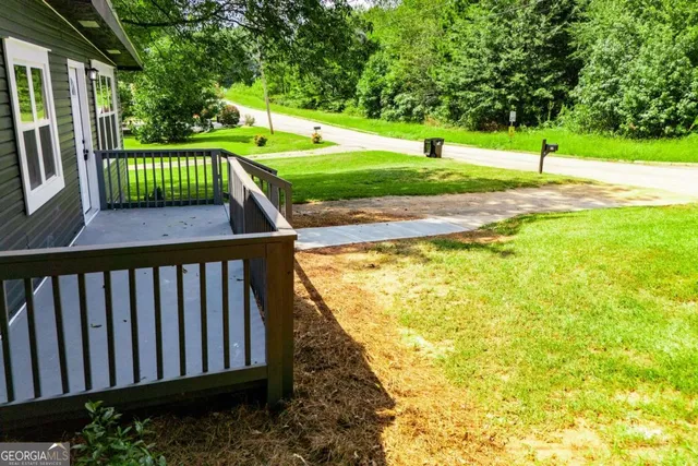 an aerial view of a residential houses with yard