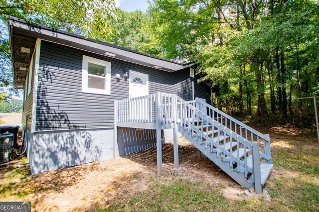 a view of a house with a small backyard