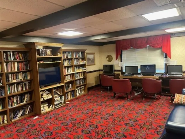 a living room with lots of furniture and a book shelf