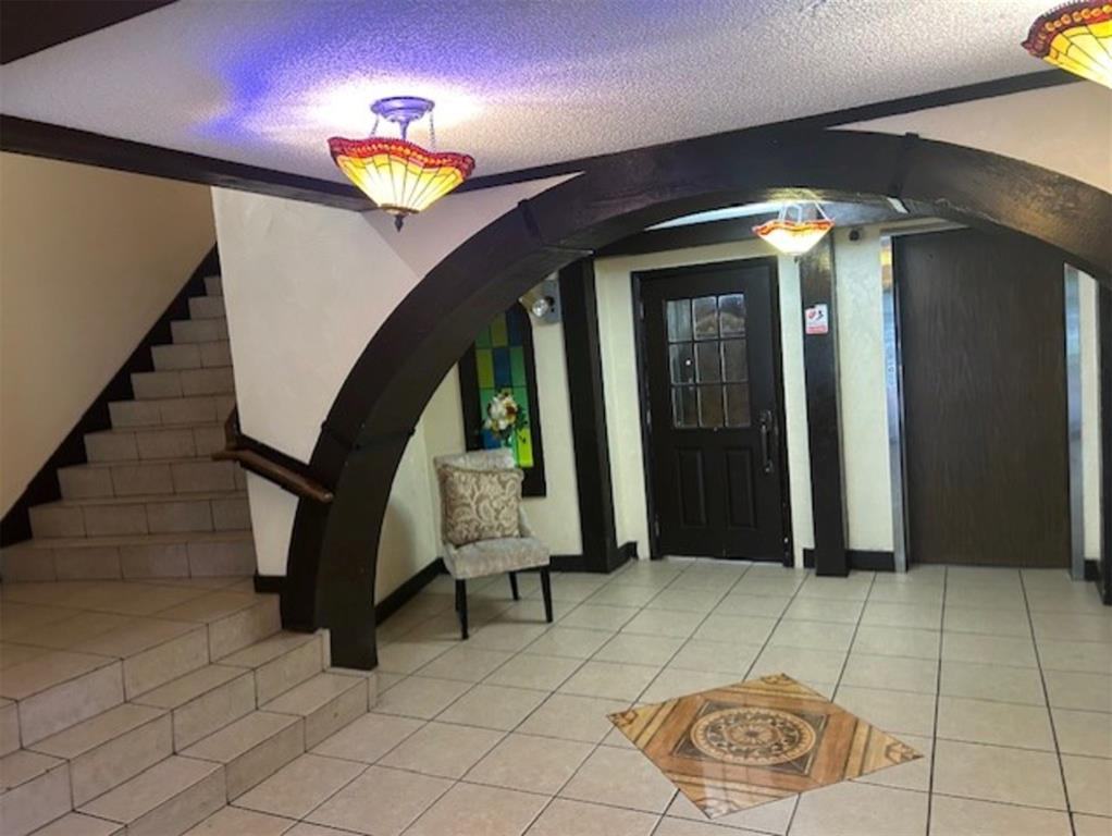 3720 Inverrary Drive, Unit 1T Lauderhill, FL 33319 - Photo 24 of 36 a view of entryway with dining room and stairs