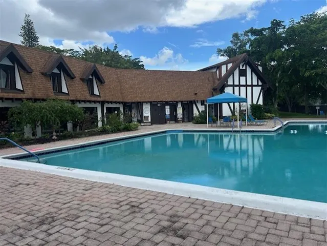 a view of a house next to a lake with a big yard