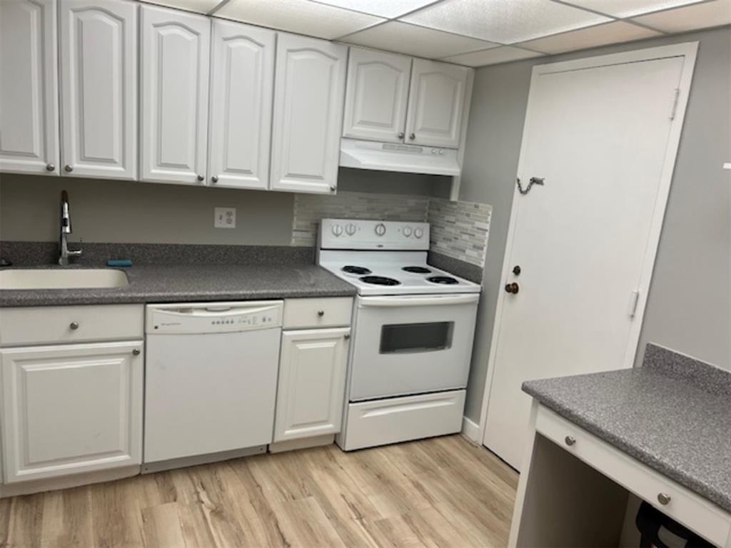 3720 Inverrary Drive, Unit 1T Lauderhill, FL 33319 - Photo 3 of 36 a kitchen with granite countertop white cabinets and white appliances