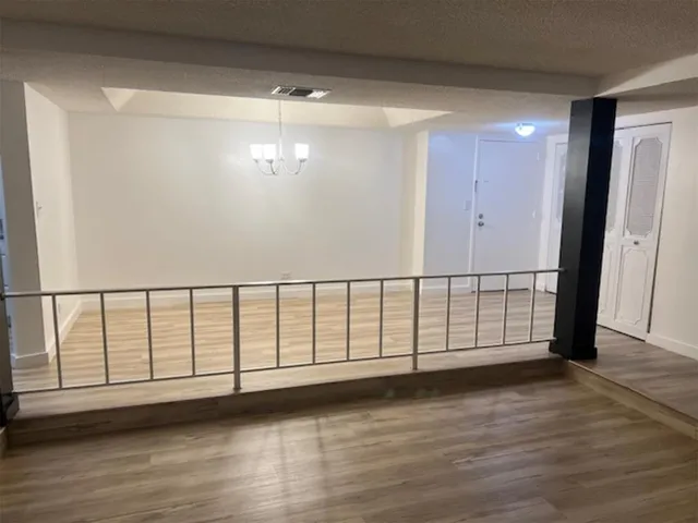 a view of staircase with wooden floor and window