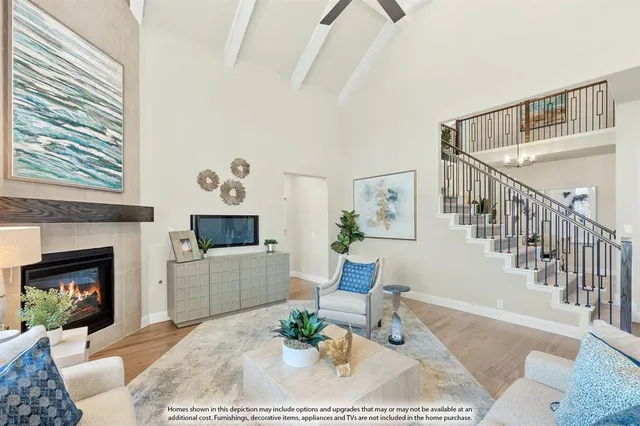 a kitchen with stainless steel appliances a sink a stove a refrigerator cabinets and a dining table