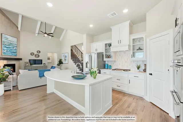 a kitchen with a stove a sink and a refrigerator
