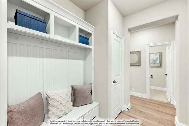 a dining room with furniture a rug and a potted plant