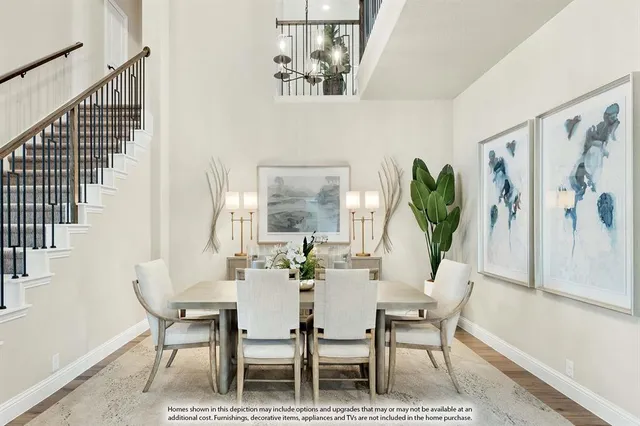 a dining room with furniture potted plants and wooden floor