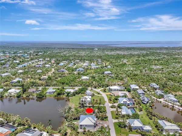 an aerial view of residential building and lake