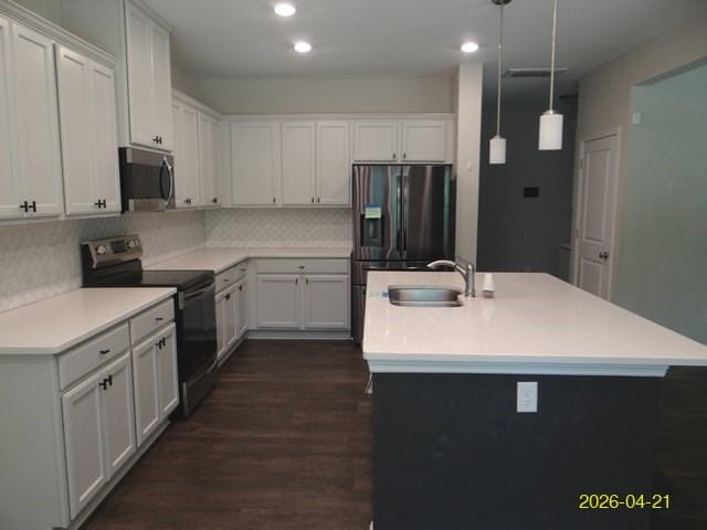 13733 Macon Road Upatoi, GA 31829 - Photo 10 of 27 a kitchen with stainless steel appliances a sink dishwasher a stove a refrigerator with white cabinets and wooden floor