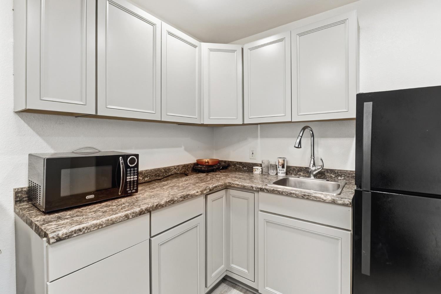 4330 Cavitt Stallman Road Granite Bay, CA 95746 - Photo 41 of 85 a kitchen with stainless steel appliances granite countertop white cabinets sink and a granite counter top