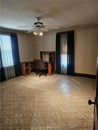 a view of a livingroom with furniture and a flat screen tv
