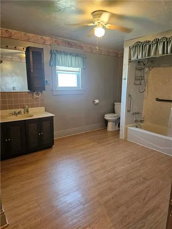 a bathroom with a sink vanity mirror and toilet