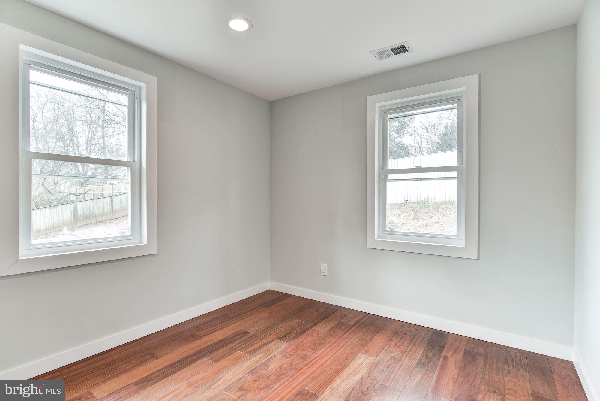 4303 Ivy Glen Road Silver Spring, MD 20906 - Photo 16 of 30 a view of an empty room with wooden floor and a window