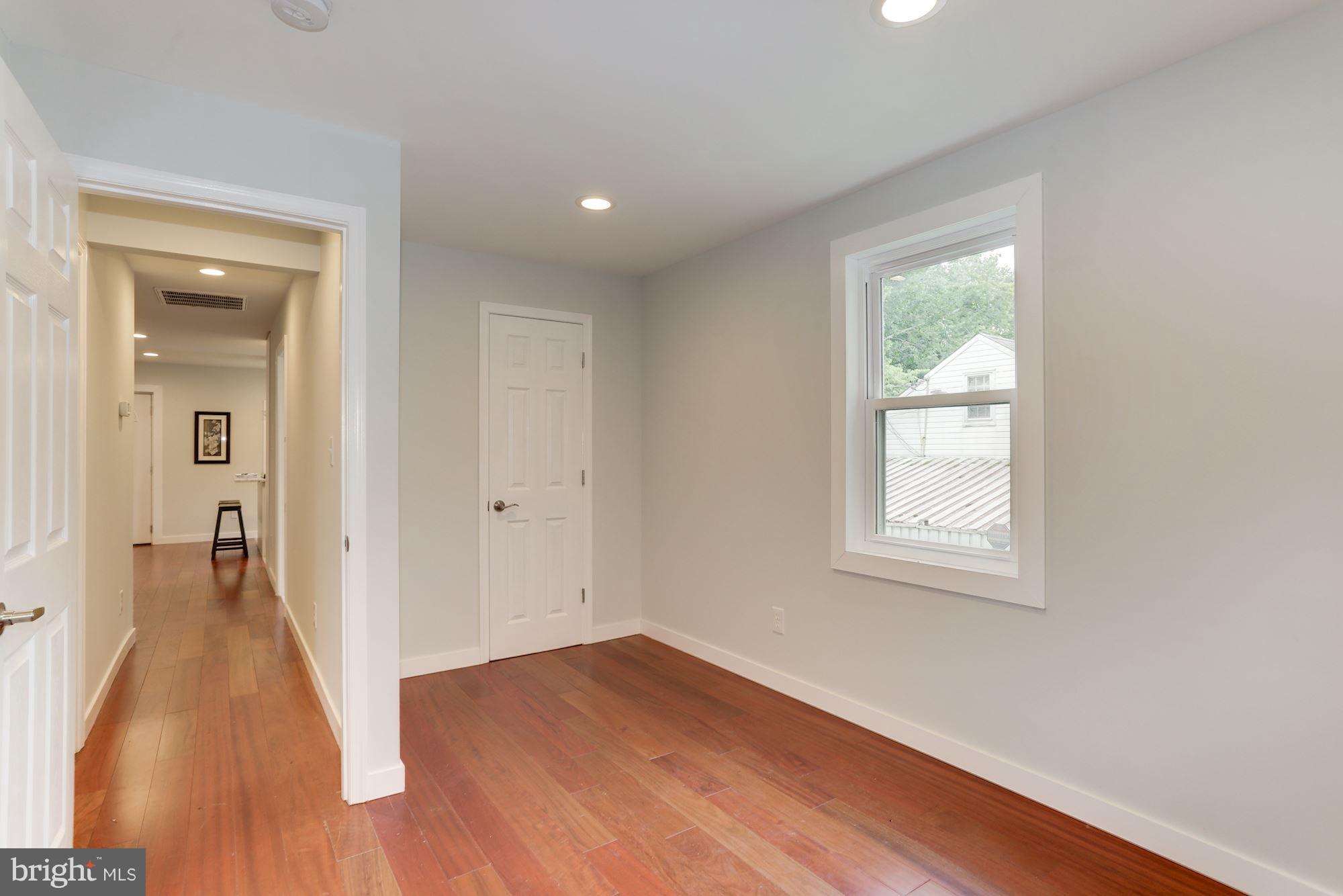 4303 Ivy Glen Road Silver Spring, MD 20906 - Photo 17 of 30 an empty room with wooden floor and a window