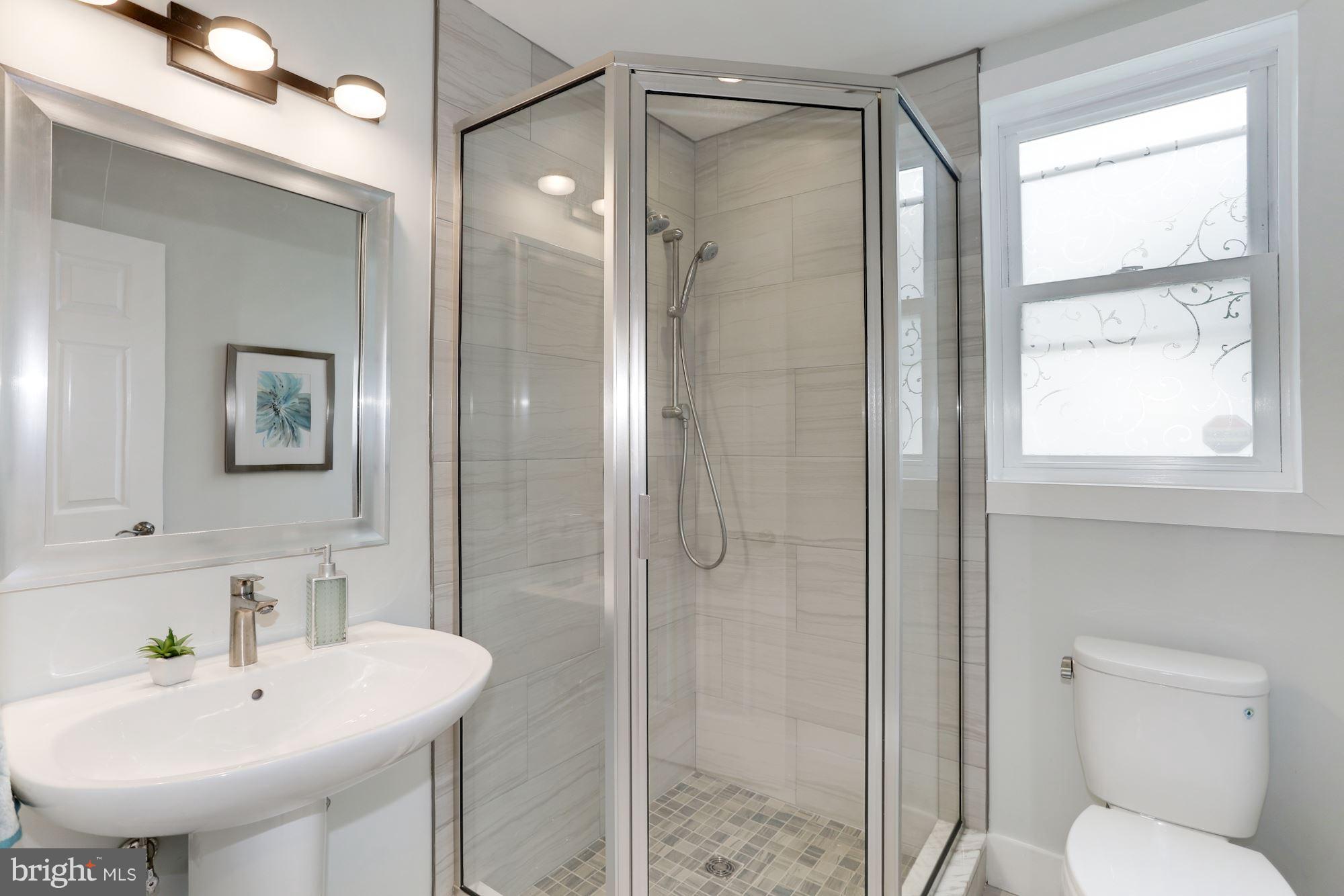4303 Ivy Glen Road Silver Spring, MD 20906 - Photo 18 of 30 a bathroom with a sink toilet and shower