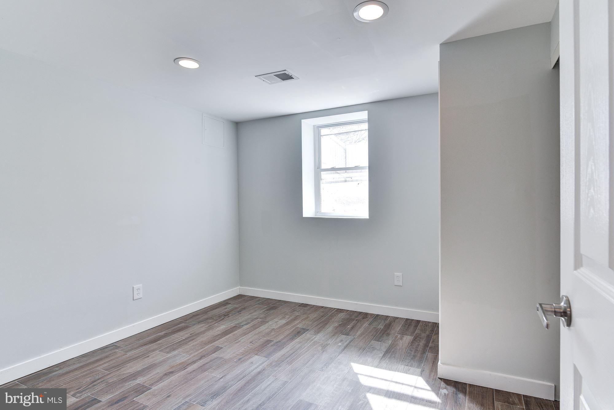 4303 Ivy Glen Road Silver Spring, MD 20906 - Photo 24 of 30 an empty room with wooden floor and windows