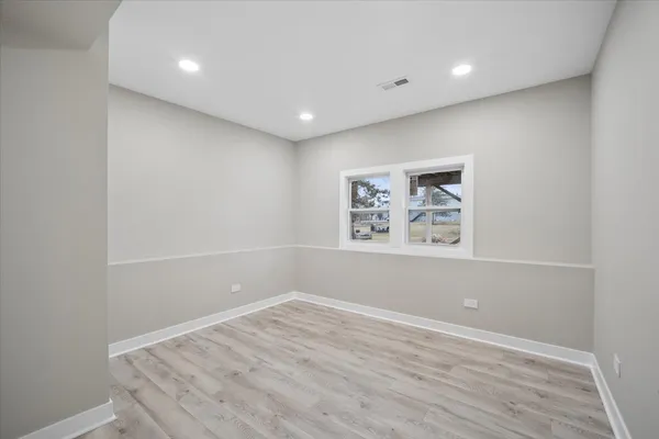 a view of room with window and wooden floor