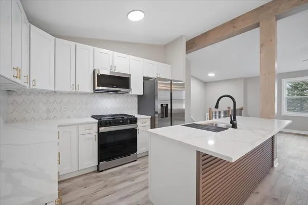 a kitchen with a sink and a stove top oven