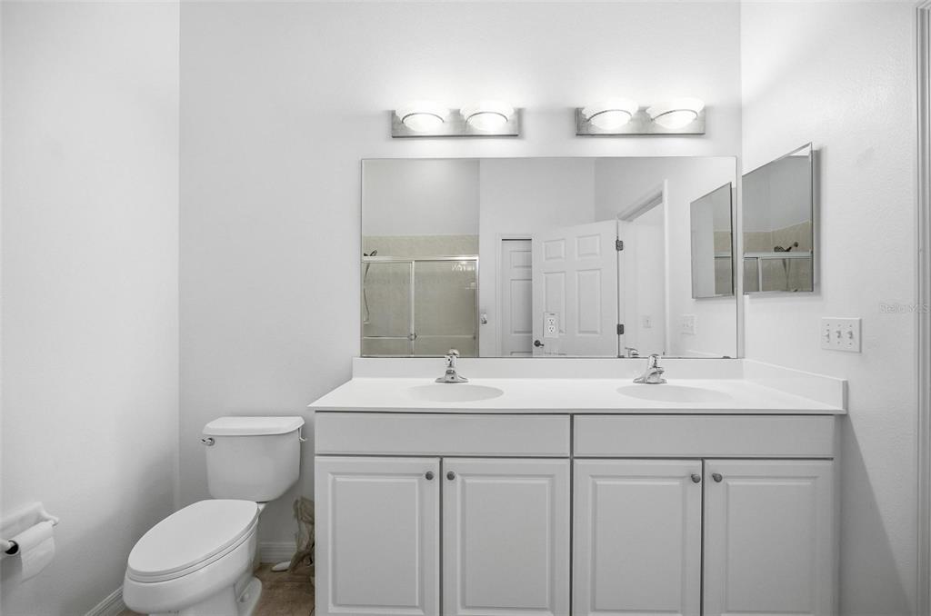 100 Canopy Walk Lane, Unit 133 Palm Coast, FL 32137 - Photo 26 of 51 a bathroom with a toilet a sink and mirror