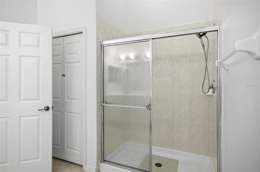 100 Canopy Walk Lane, Unit 133 Palm Coast, FL 32137 - Photo 27 of 51 a bathroom with a glass shower door