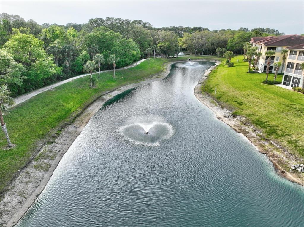 100 Canopy Walk Lane, Unit 133 Palm Coast, FL 32137 - Photo 32 of 51 a view of a lake with a yard