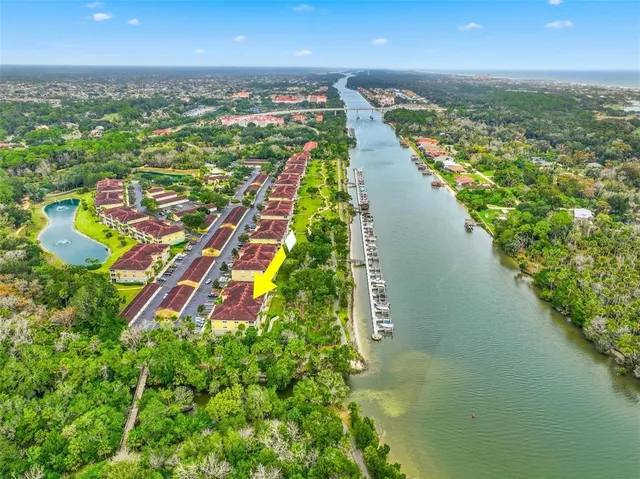 an aerial view of residential houses with outdoor space and river