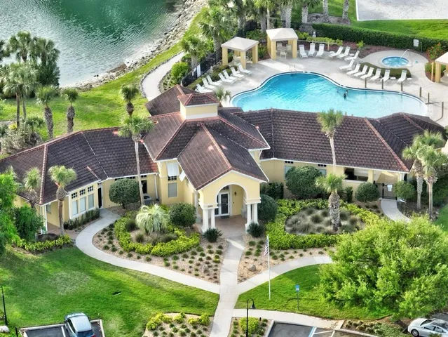 a front view of a house with a garden and trees