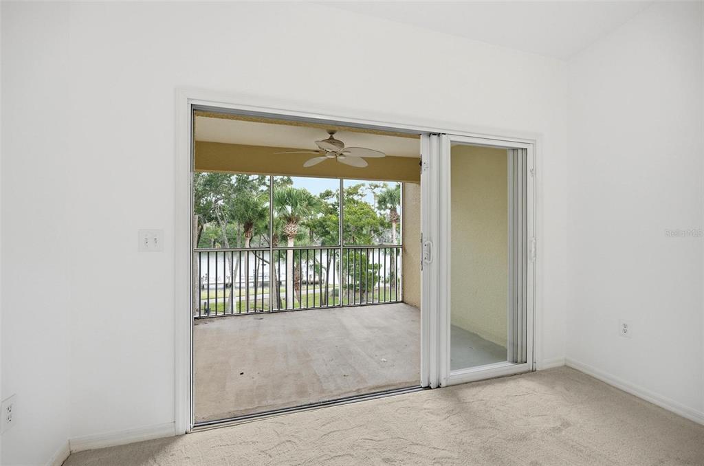 100 Canopy Walk Lane, Unit 133 Palm Coast, FL 32137 - Photo 4 of 51 an empty room with wooden floor and windows