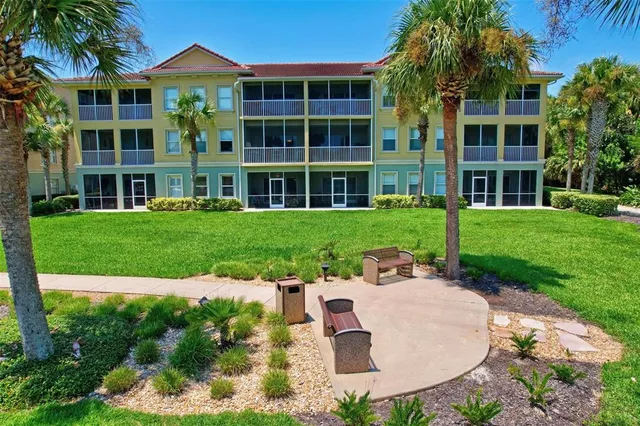 an aerial view of a house with a garden and lake view