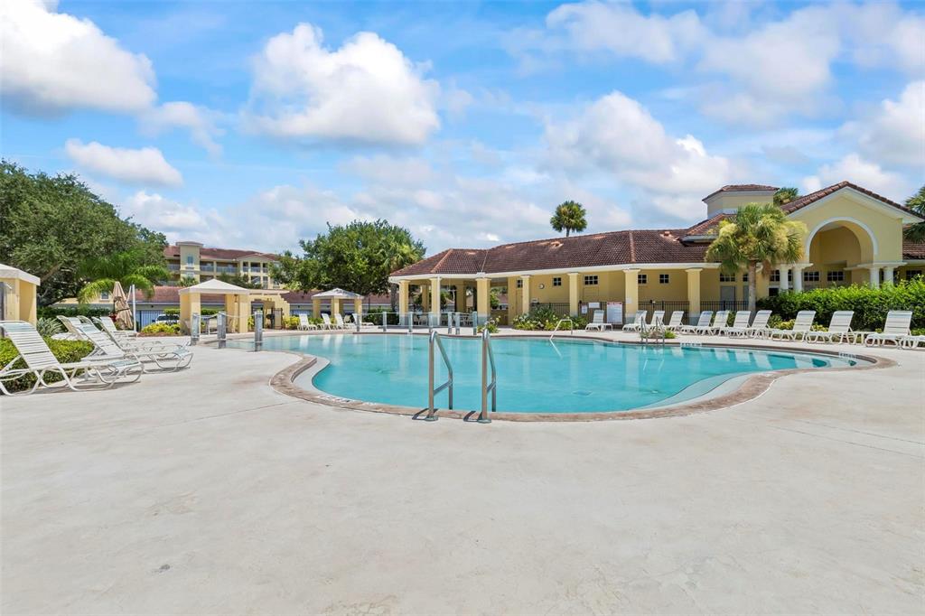 100 Canopy Walk Lane, Unit 133 Palm Coast, FL 32137 - Photo 42 of 51 a view of a swimming pool and a buildings in the background