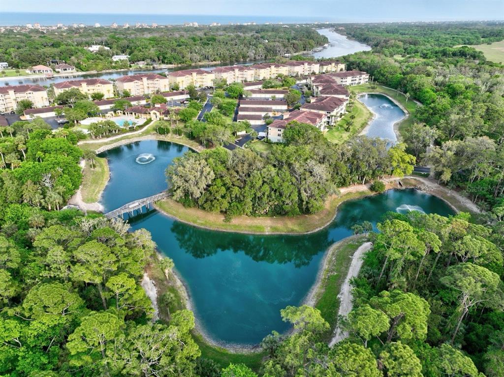 100 Canopy Walk Lane, Unit 133 Palm Coast, FL 32137 - Photo 46 of 51 an aerial view of residential houses with outdoor space and trees