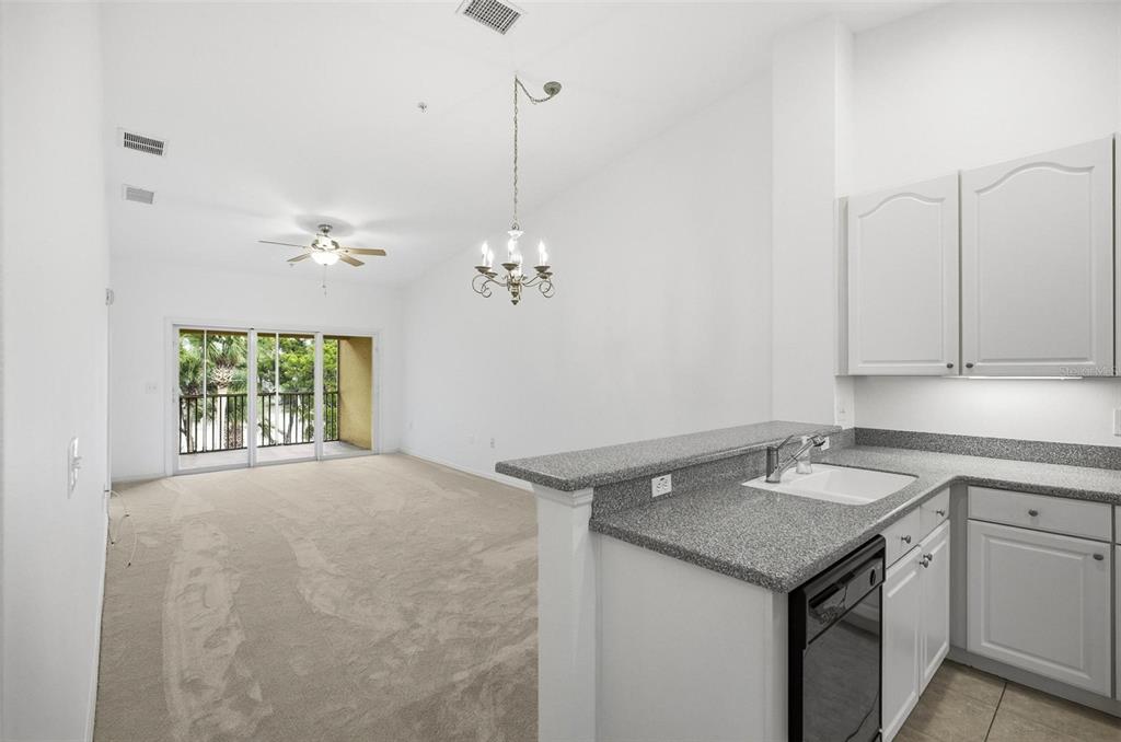 100 Canopy Walk Lane, Unit 133 Palm Coast, FL 32137 - Photo 10 of 51 a view of a kitchen with a sink cabinets and window